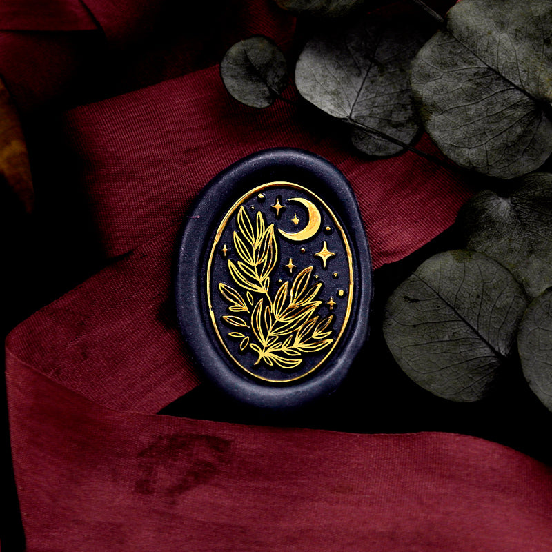 Wax Seal Stamp, created an oval green wax seal on a blue ribbon with leaves moon stars design