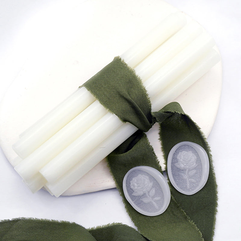 Sealing Wax Sticks in Translucent White with dark green wedding packing cloth wrapped, beside them, two rose flower pattern wax seals samples created.