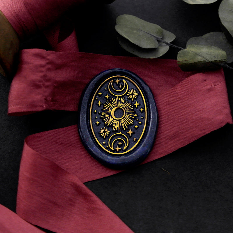 Wax Seal Stamp, created an oval blue wax seal on a red ribbon with moon and stars design .