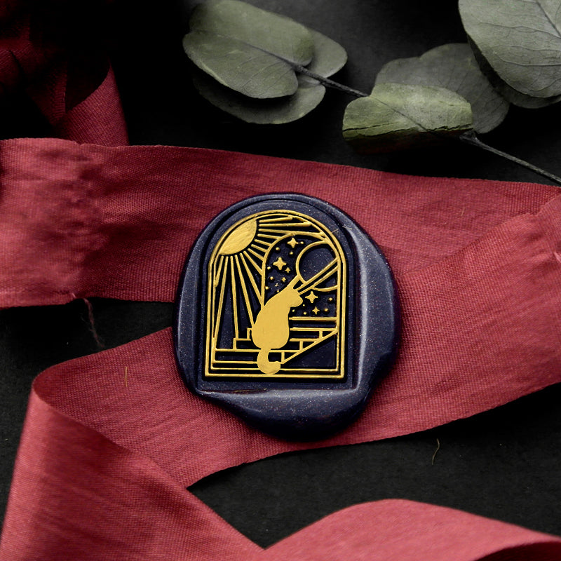 Wax Seal Stamp, created a blue wax seal on a red ribbon with arch door window moon stars cat and stairs design .