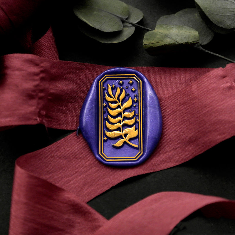 Wax Seal Stamp, created an rectangle blue wax seal on a red ribbon with starry night leaves design