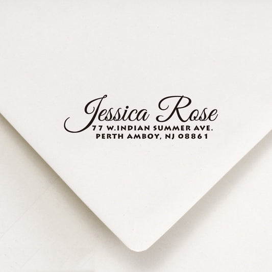 A personalized self inking return address stamp, customized with your name and address, stamped on the white envelope.