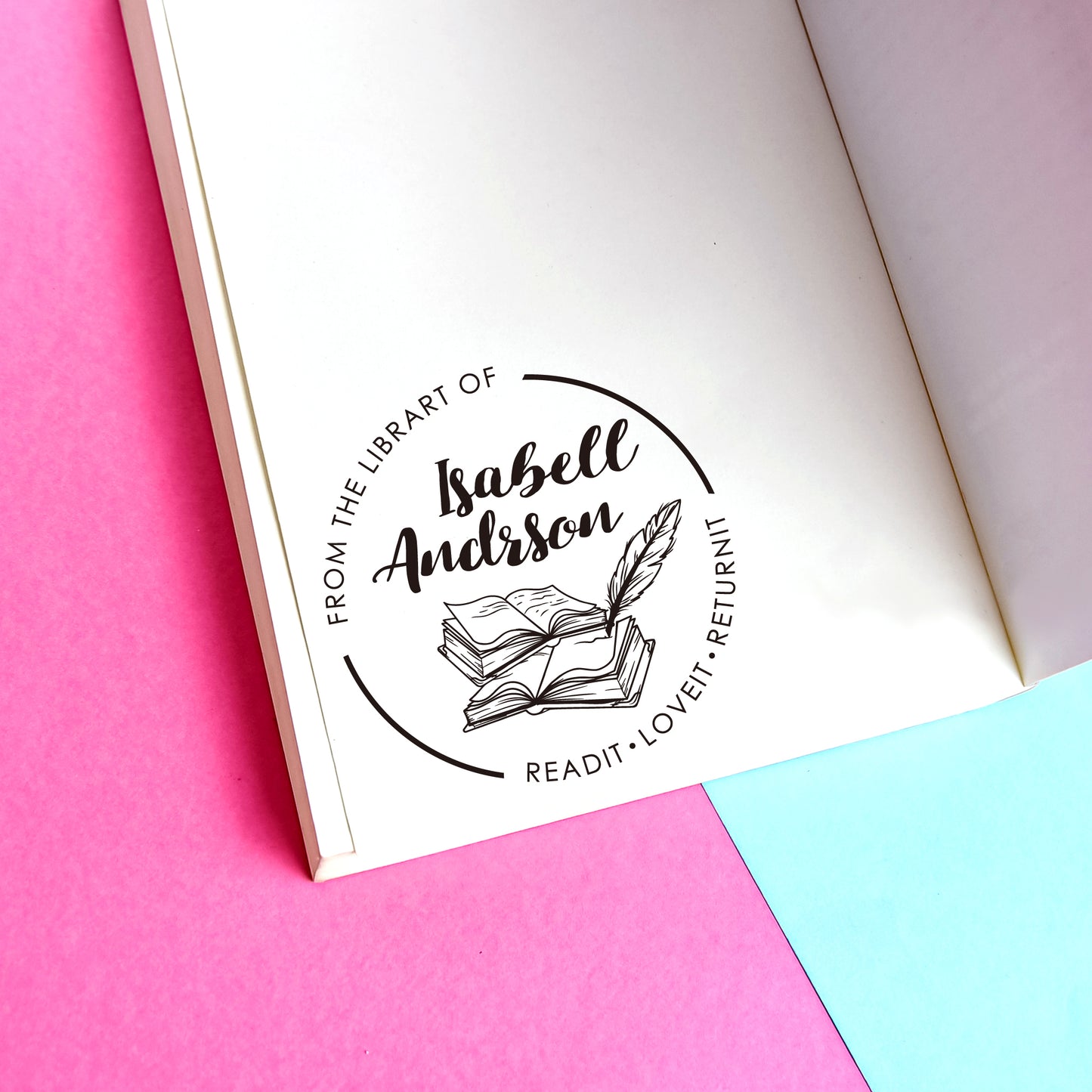 A personalized book stamp, shaped like round, the center is graphic of books and feather and custom your name, surrounded with words from the library of and read it. love it. return it.