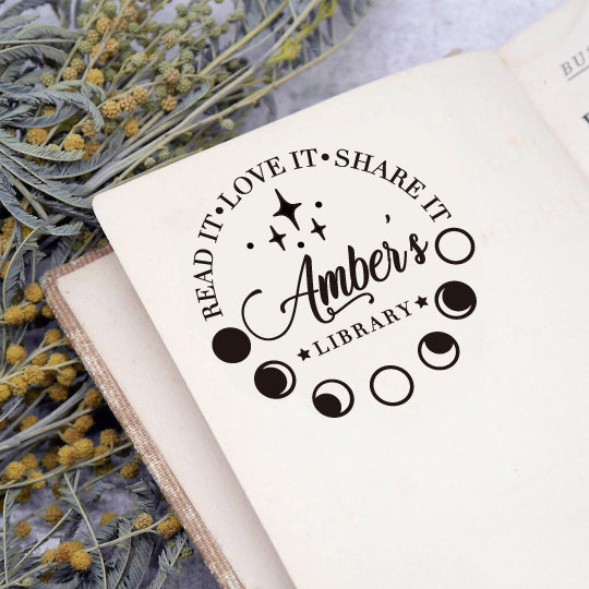 A personalized book stamp in round, the top is text -Read It Love It Share It, the centre is to custom your free library name, the bottom is the graphic of moon phases.