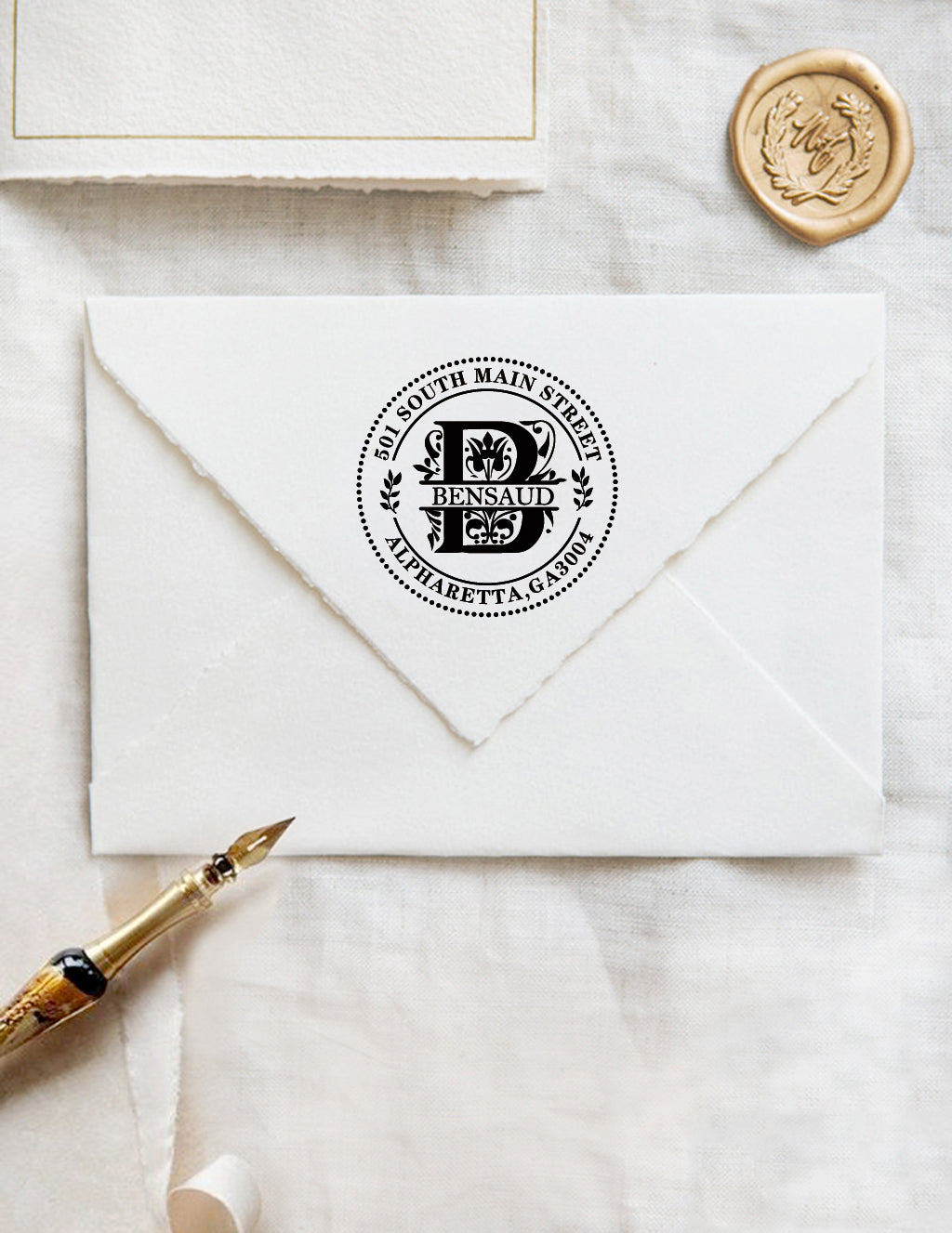 A personalized self inking wedding address stamp, customized with your name, address, initial and leaves, stamped on the white envelope, beside it, a wax seal is waiting for sealing the mail.