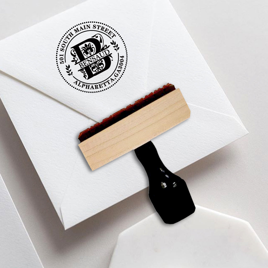 A personalized self inking address stamp, customized with your name, Initial, leaves and address, stamped on the invitation card.