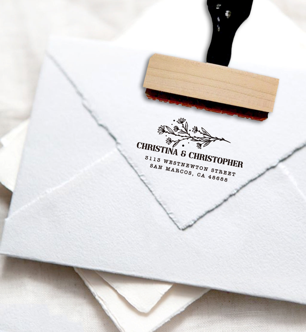 A personalized self inking address stamp, customized with your name, address and flower, stamped on the white envelope.