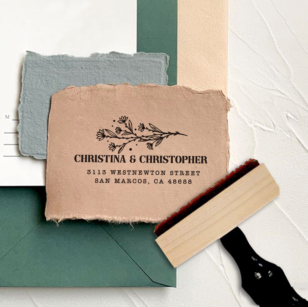 A personalized self inking address stamp, customized with your name, address and flower, stamped on the craft paper.