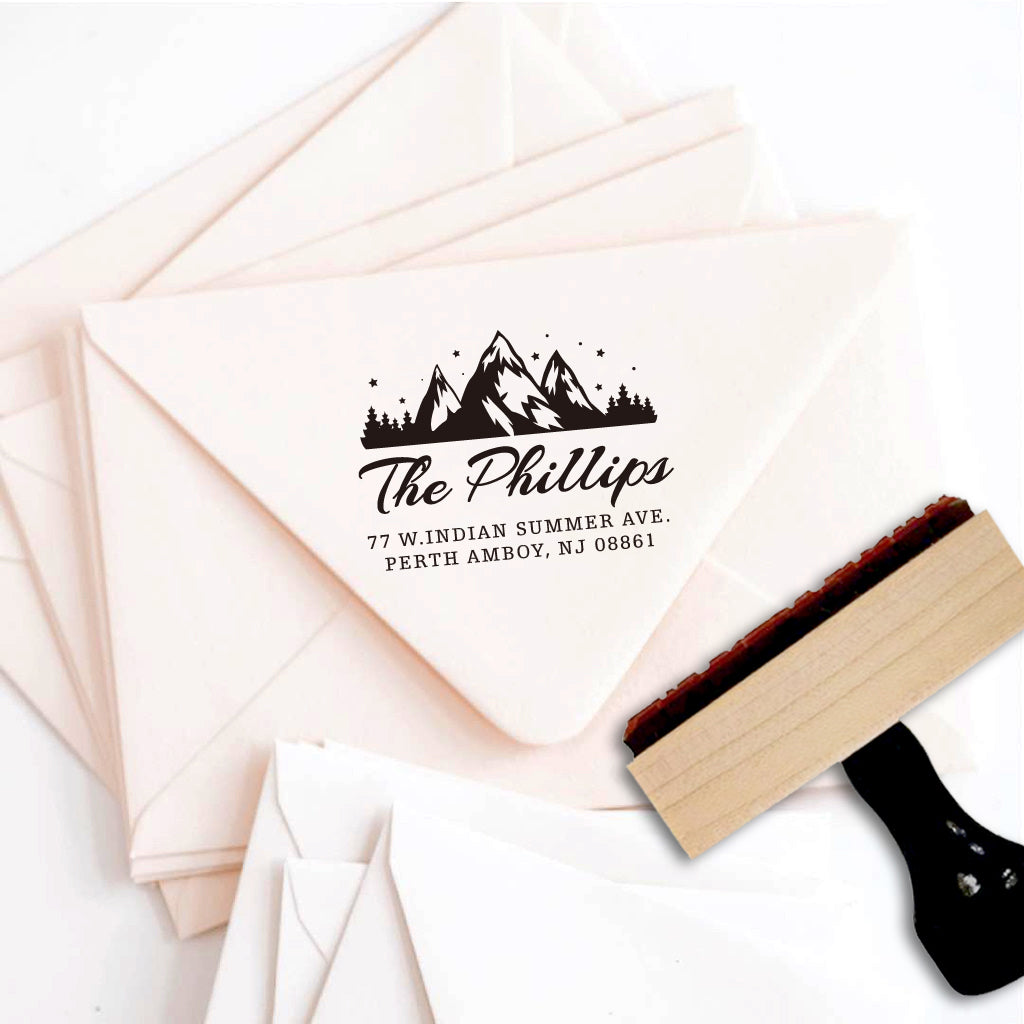 A personalized self inking return address stamp, customized with your mountain logo name and address, stamped on the pink envelope.