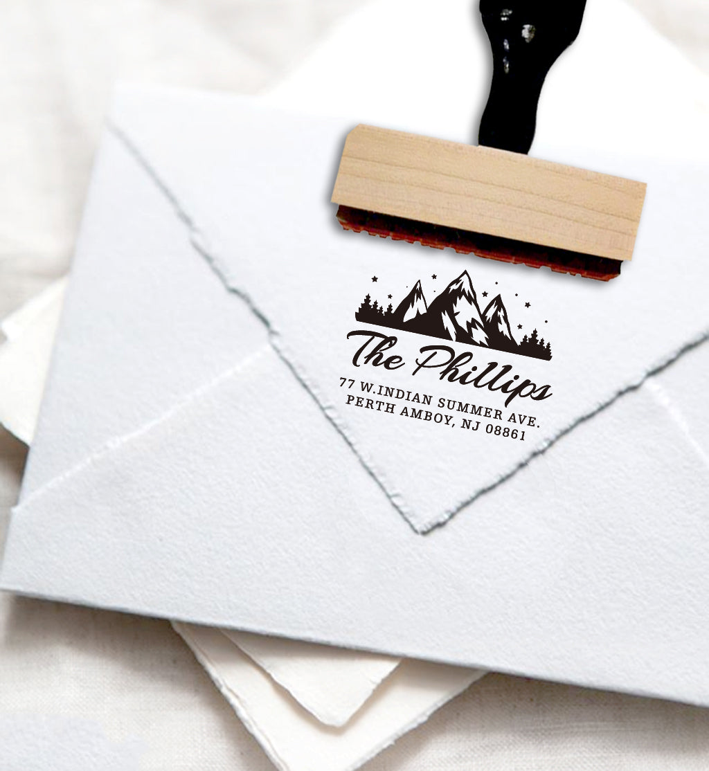 A personalized self inking return address stamp, customized with your mountain logo name and address, stamped on the white envelope.