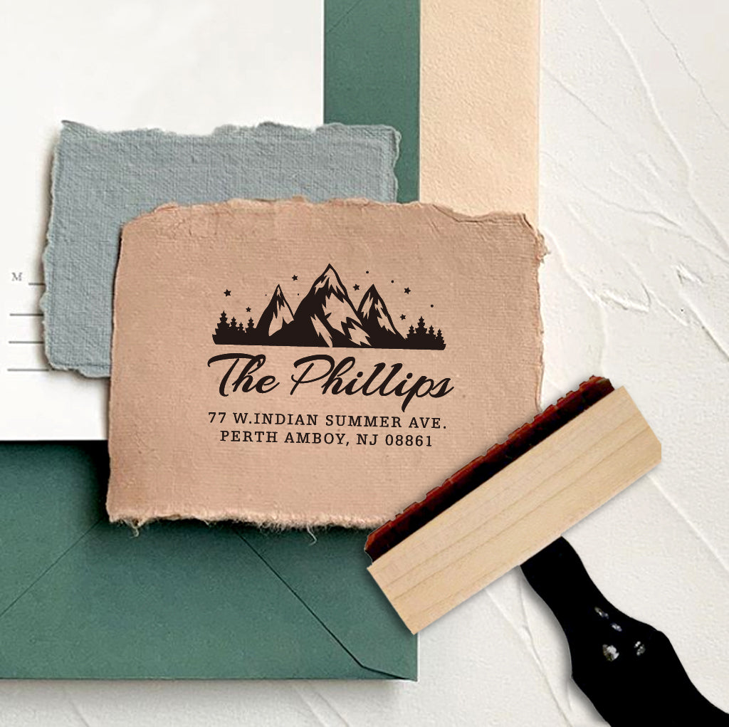 A personalized self inking return address stamp, customized with your mountain logo name and address, stamped on the craft paper.