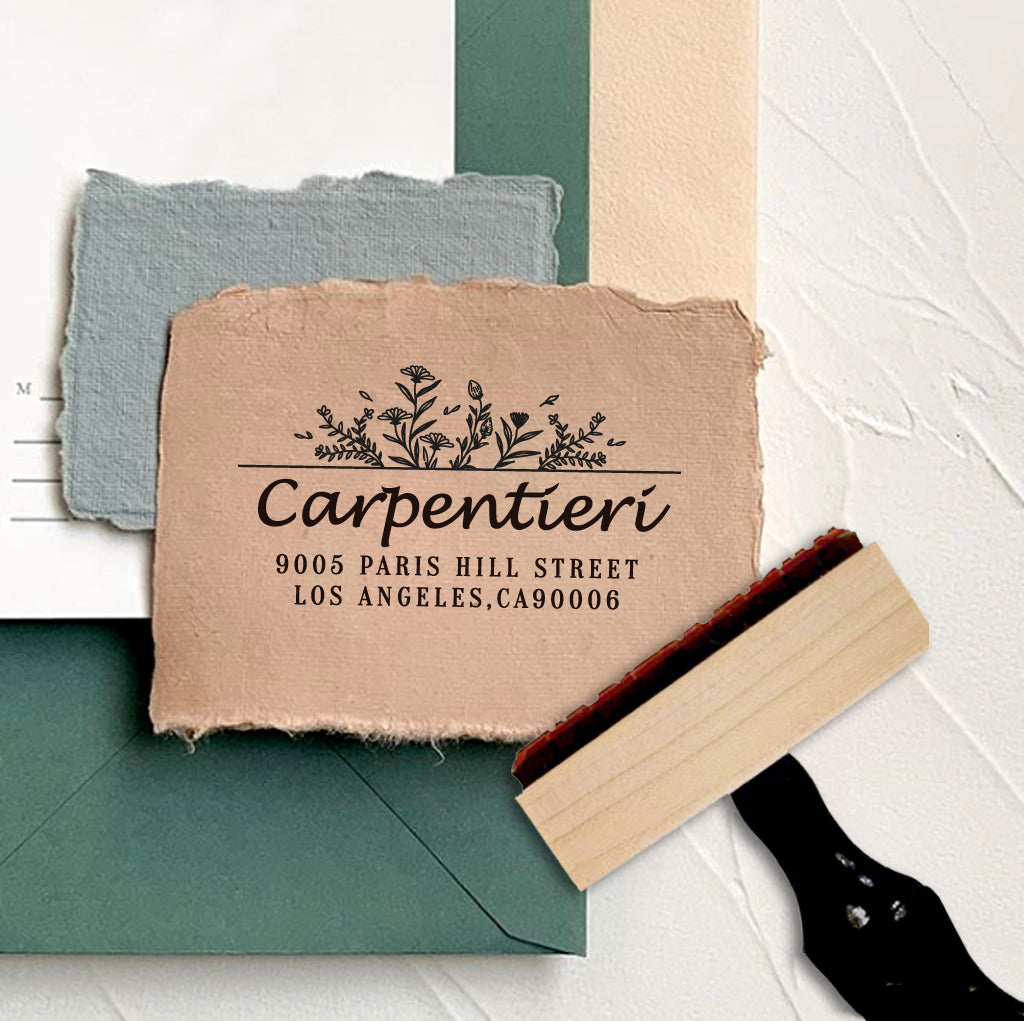 A personalized self inking address stamp, customized with your name, address and flower, stamped on the craft paper.