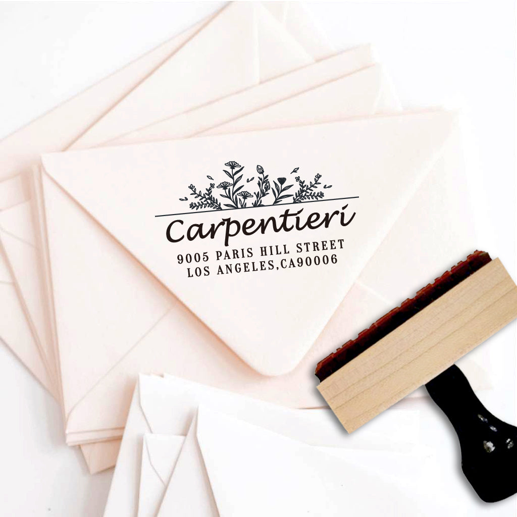 A personalized self inking address stamp, customized with your name, address and flower, stamped on the pink envelope.