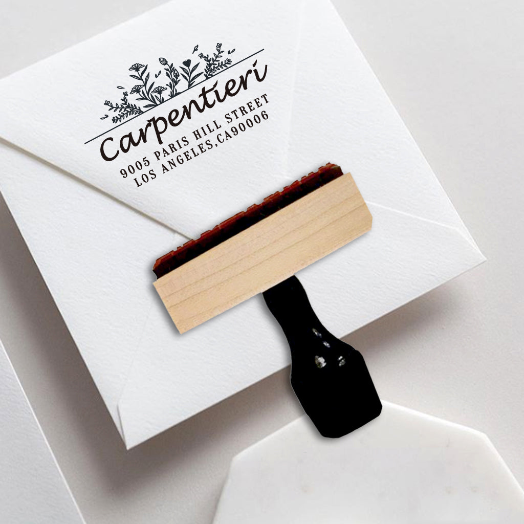 A personalized self inking address stamp, customized with your name, address and flower, stamped on the invitation card.