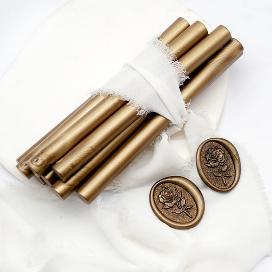 Sealing Wax Sticks in bronze with white wedding packing cloth wrapped, beside them, two rose flower pattern wax seals samples created.