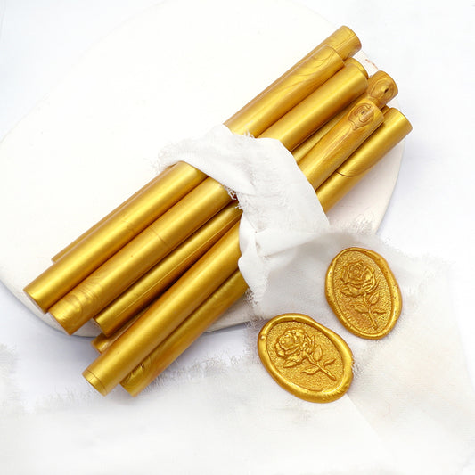 Sealing Wax Sticks in gold with white wedding packing cloth wrapped, beside them, two rose flower pattern wax seals samples created.