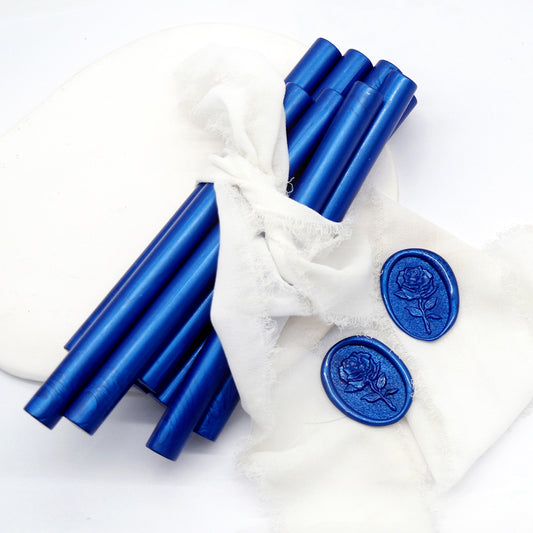 Sealing Wax Sticks in Metallic Navy Blue with white wedding packing cloth wrapped, beside them, two rose flower pattern wax seals samples created.