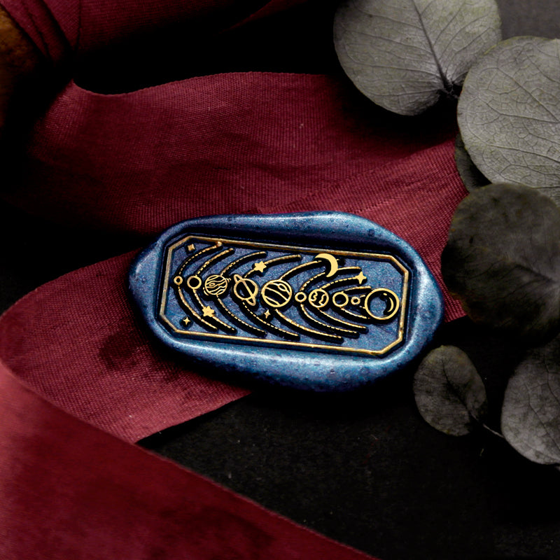 Wax Seal Stamp, created a wax seal on a red ribbon with planets moon stars design