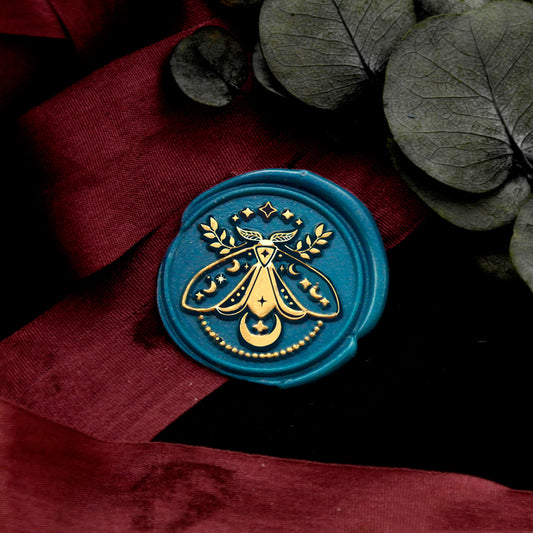 Wax Seal Stamp, created a wax seal on a red ribbon with moth design .