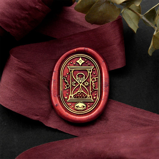 Wax Seal Stamp, created a wax seal on a red ribbon with skull hourglass design