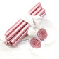 Sealing Wax Sticks in Rose Gold Pink with white wedding packing cloth wrapped, beside them, two rose flower pattern wax seals samples created.