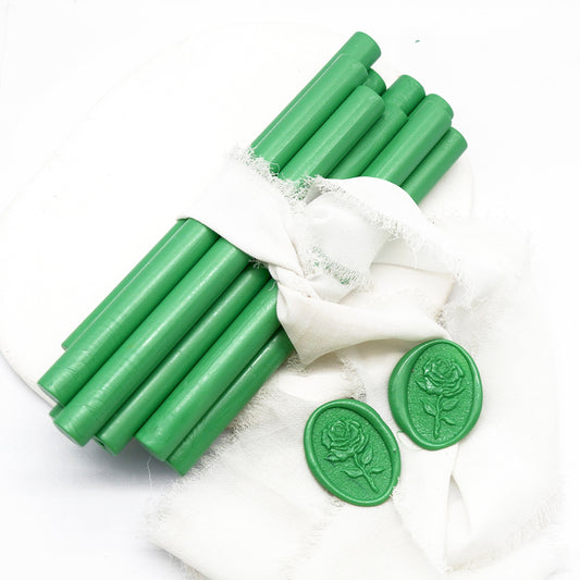 Sealing Wax Sticks in jade green with white wedding packing cloth wrapped, beside them, two rose flower pattern wax seals samples created.