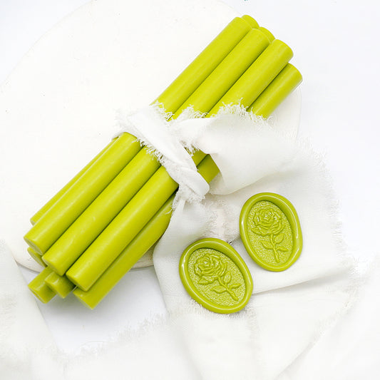 Sealing Wax Sticks in olive green with white wedding packing cloth wrapped, beside them, two rose flower pattern wax seals samples created.
