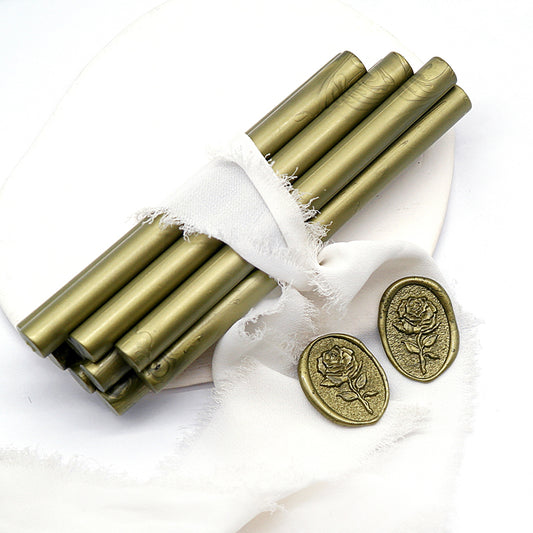 Sealing Wax Sticks in Metallic Army Green with white wedding packing cloth wrapped, beside them, two rose flower pattern wax seals samples created.