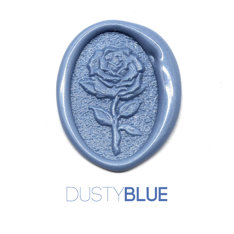 a rose flower wax seal just to show the effect of dusty blue sealing wax beads.