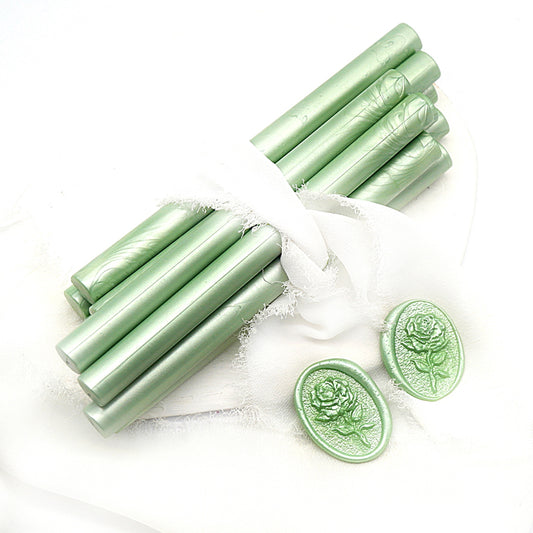 Sealing Wax Sticks in mint green with white wedding packing cloth wrapped, beside them, two rose flower pattern wax seals samples created.
