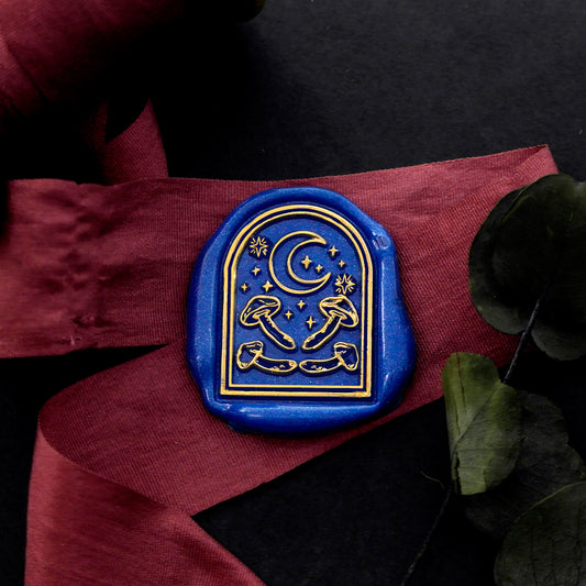 Wax Seal Stamp, created a blue wax seal on a red ribbon with arch window stars moon mushroom design .