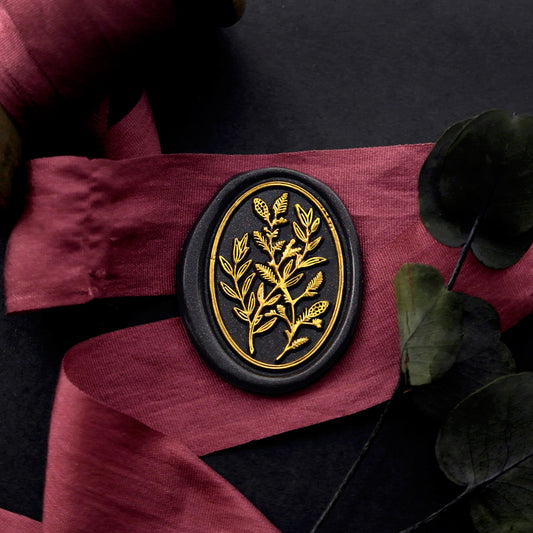 Wax Seal Stamp, created an oval black wax seal on a red ribbon with plant leaves design .