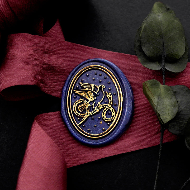 Wax Seal Stamp, created an oval blue wax seal on a red ribbon with bird and snake design .