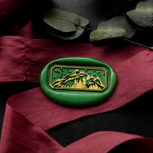 Wax Seal Stamp, created a green wax seal on a red ribbon with Mountains Forest Starry Night design