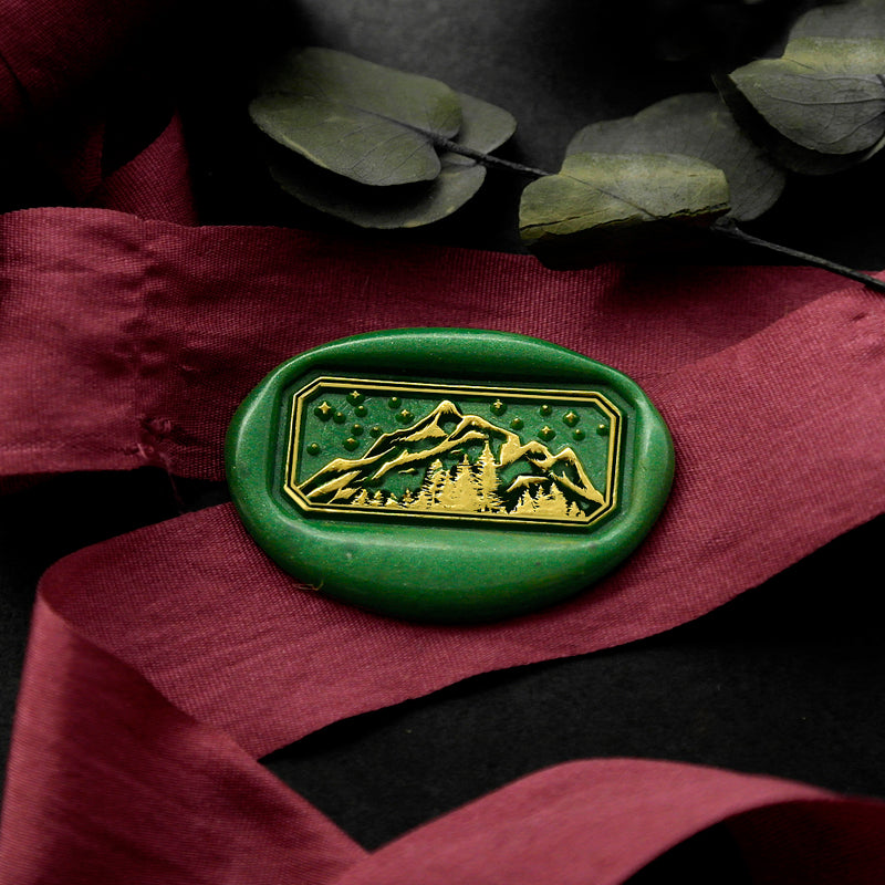 Wax Seal Stamp, created a green wax seal on a red ribbon with Mountains Forest Starry Night design