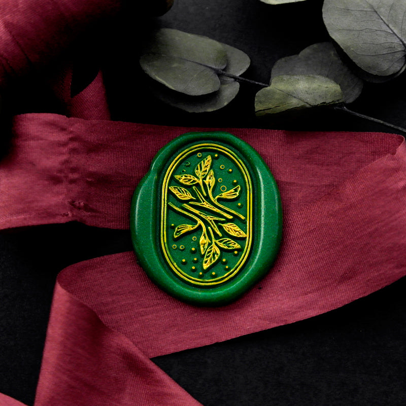 Wax Seal Stamp, created an oval green wax seal on a red ribbon with leaves plant design