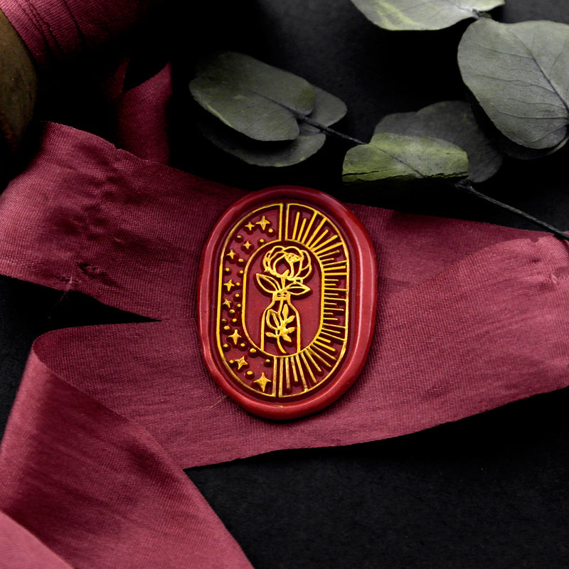 Wax Seal Stamp, created an oval red wax seal on a red ribbon with rose vase moon sun design