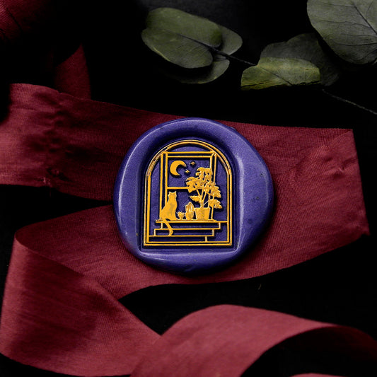 Wax Seal Stamp, created a blue wax seal on a red ribbon with arch door window moon stars cat and monstera design .