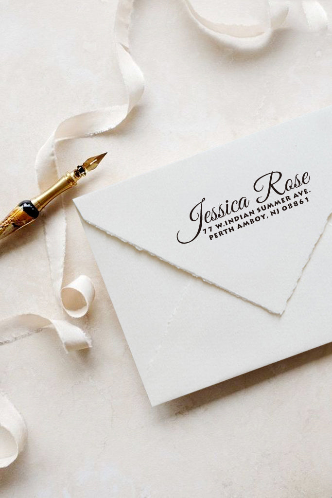 A personalized self inking address stamp, customized with your name and address, stamped on the white envelop, beside it, a ribbon is waiting for packing the gift.