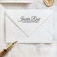 A personalized self inking address stamp, customized with your name and address, stamped on the white envelope, beside it, a wax seal is waiting for sealing the mail. 