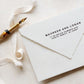 A personalized wedding self inking address stamp, customized with your name and address, stamped on the white envelop, beside it, a ribbon is waiting for packing the gift.