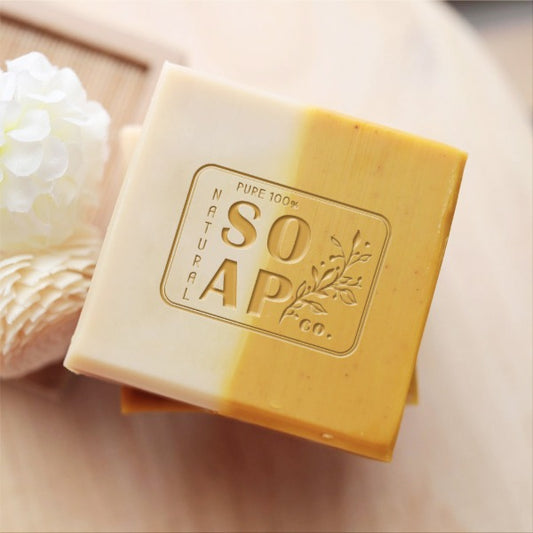 Custom Soap Stamp, with graphic of rectangle, flower and "100% pure Natural Soap"words, imprinted on handmade soap.