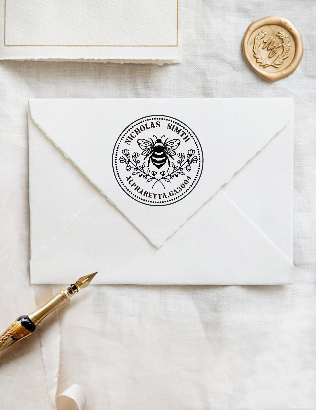A personalized self inking address stamp, customized with your name and address, bee and flower, stamped on the white envelope, beside it, a wax seal is waiting for sealing the mail.