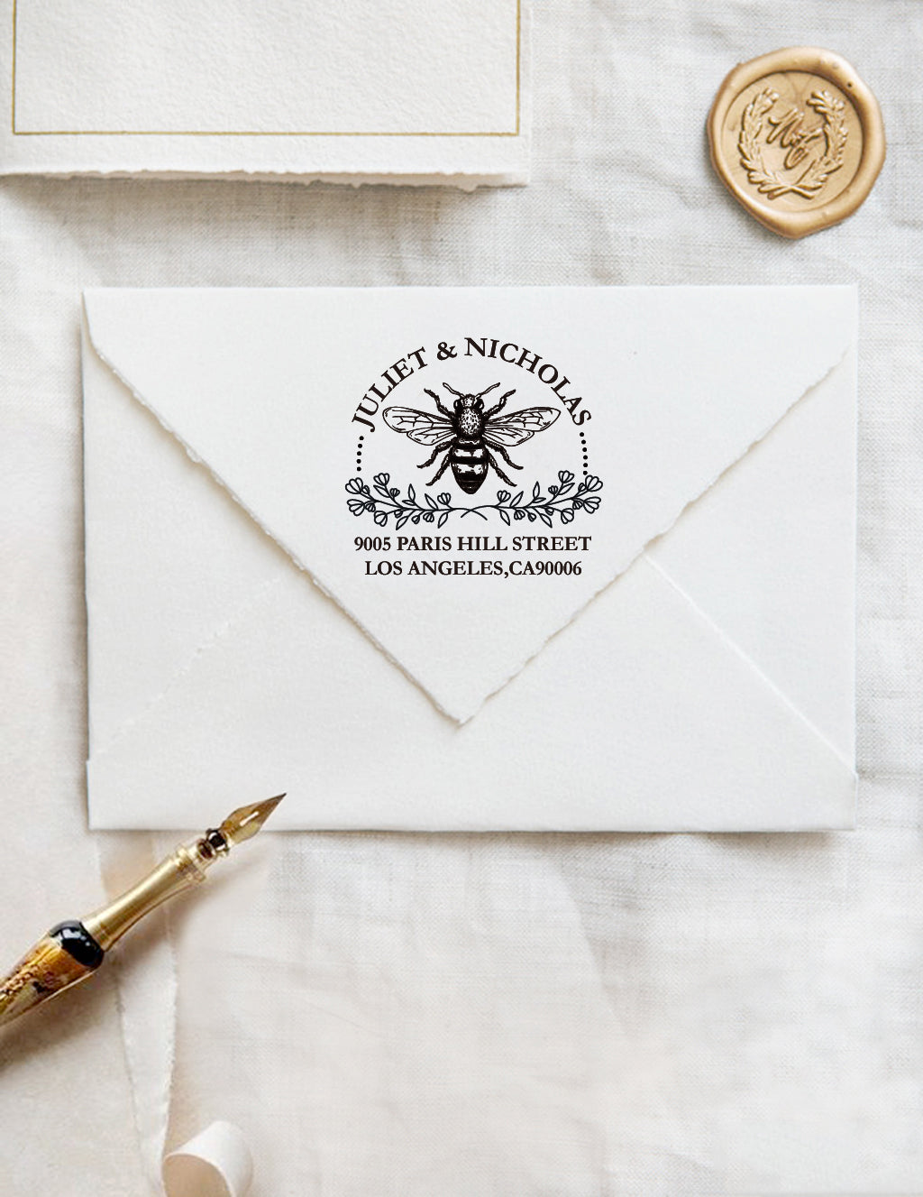 A personalized self inking wedding address stamp, customized with your name and address, bee and flower, stamped on the white envelope, beside it, a wax seal is waiting for sealing the mail.