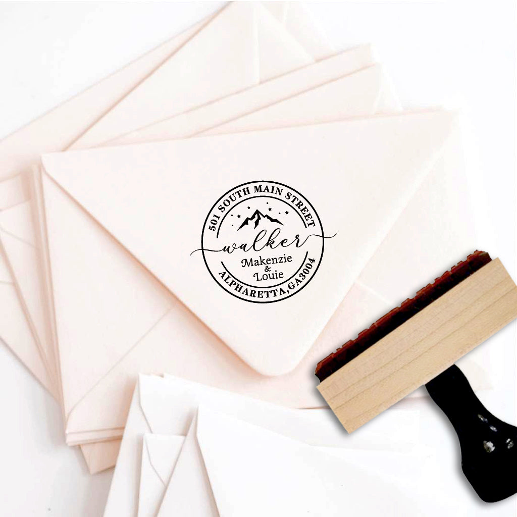 A personalized self inking address stamp, customized with your name, address and mountain, stamped on pink envelope.