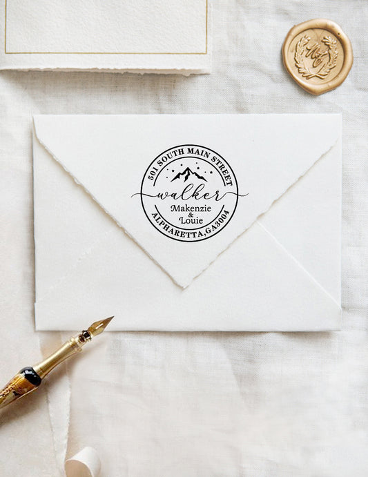 A personalized self inking wedding address stamp, customized with your name, address and mountain, stamped on the white envelope, beside it, a wax seal is waiting for sealing the mail.