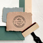 A personalized self inking address stamp, customized with your name, address and mountain, stamped on the craft paper.