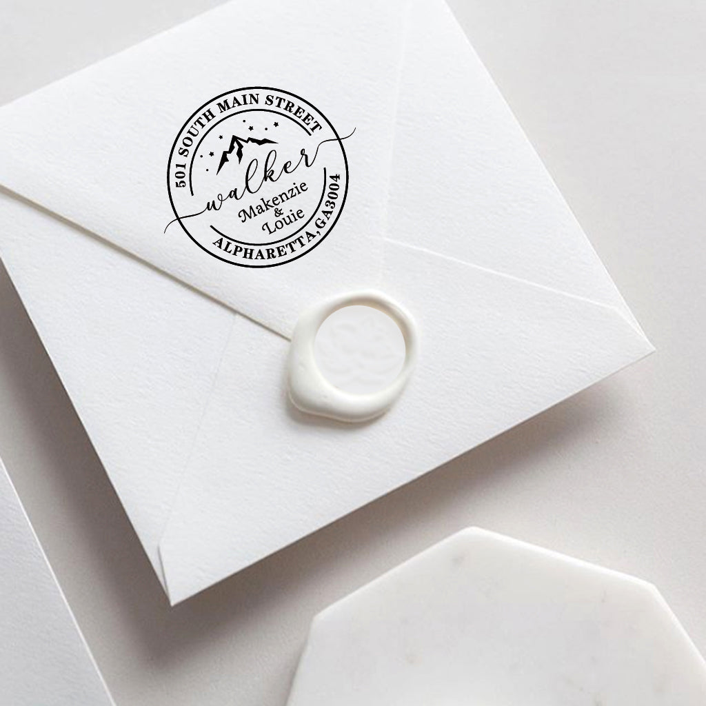 A self inking return address stamp, customized with your name, address and mountain, stamped on the white envelop of invitation card, a wax seal sealed the envelope.