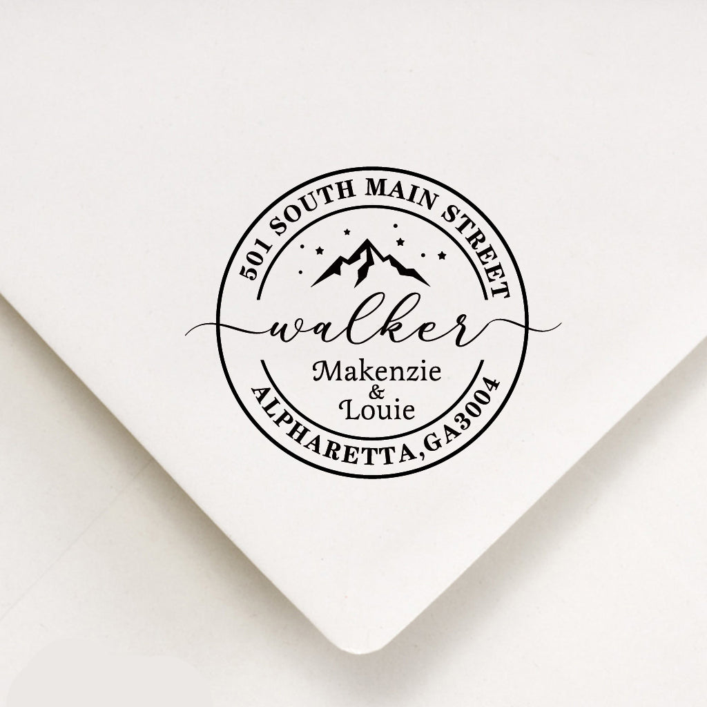A personalized self inking address stamp, customized with your name, address and mountain, stamped on white envelope.