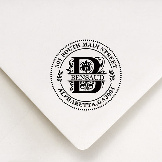 A personalized self inking address stamp, customized with your name, Initial, leaves and address, stamped on the white envelope.